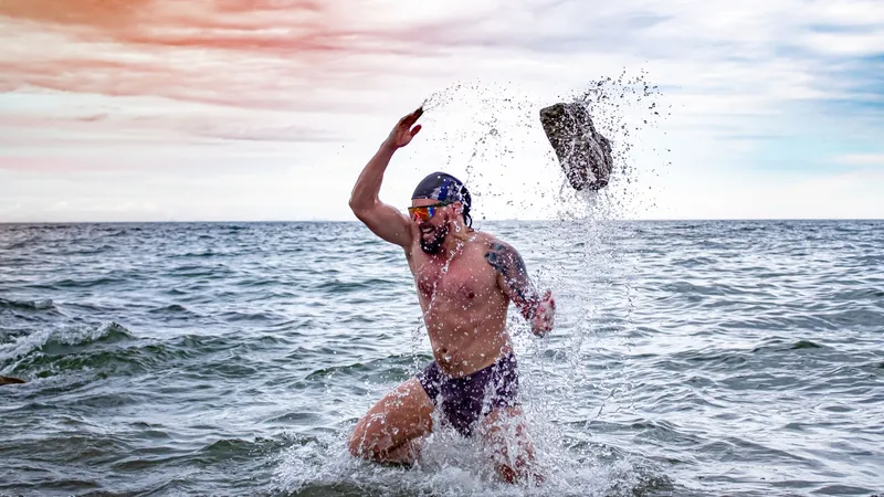 Josh throwing a rock in the surf