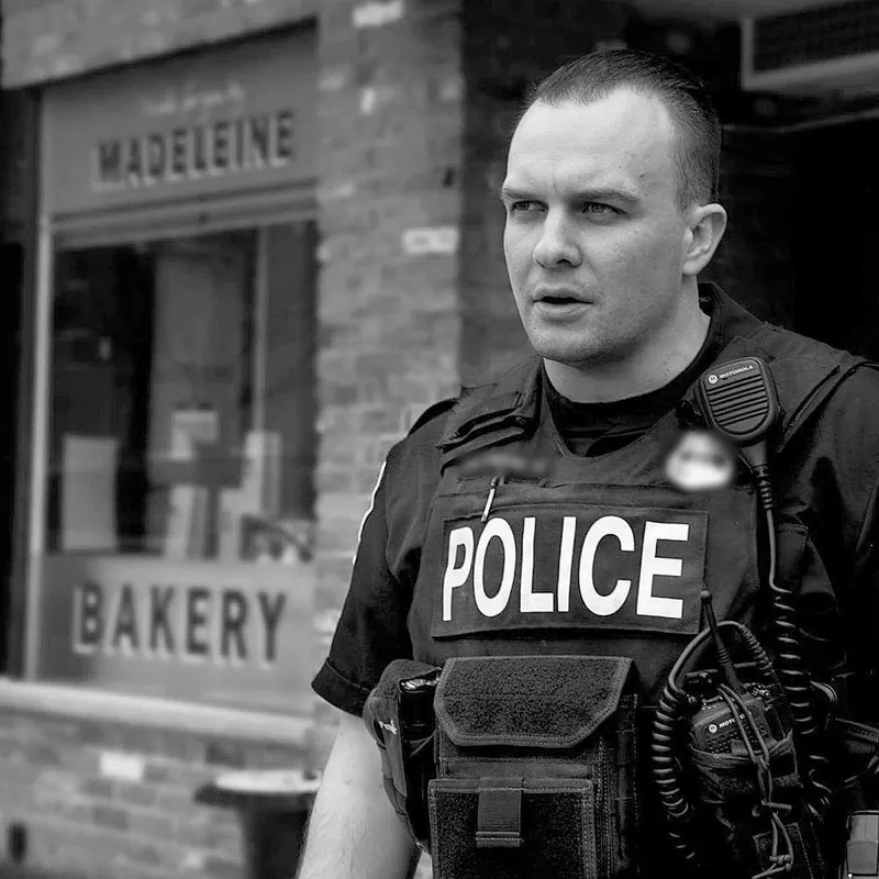Josh in police uniform, black and white